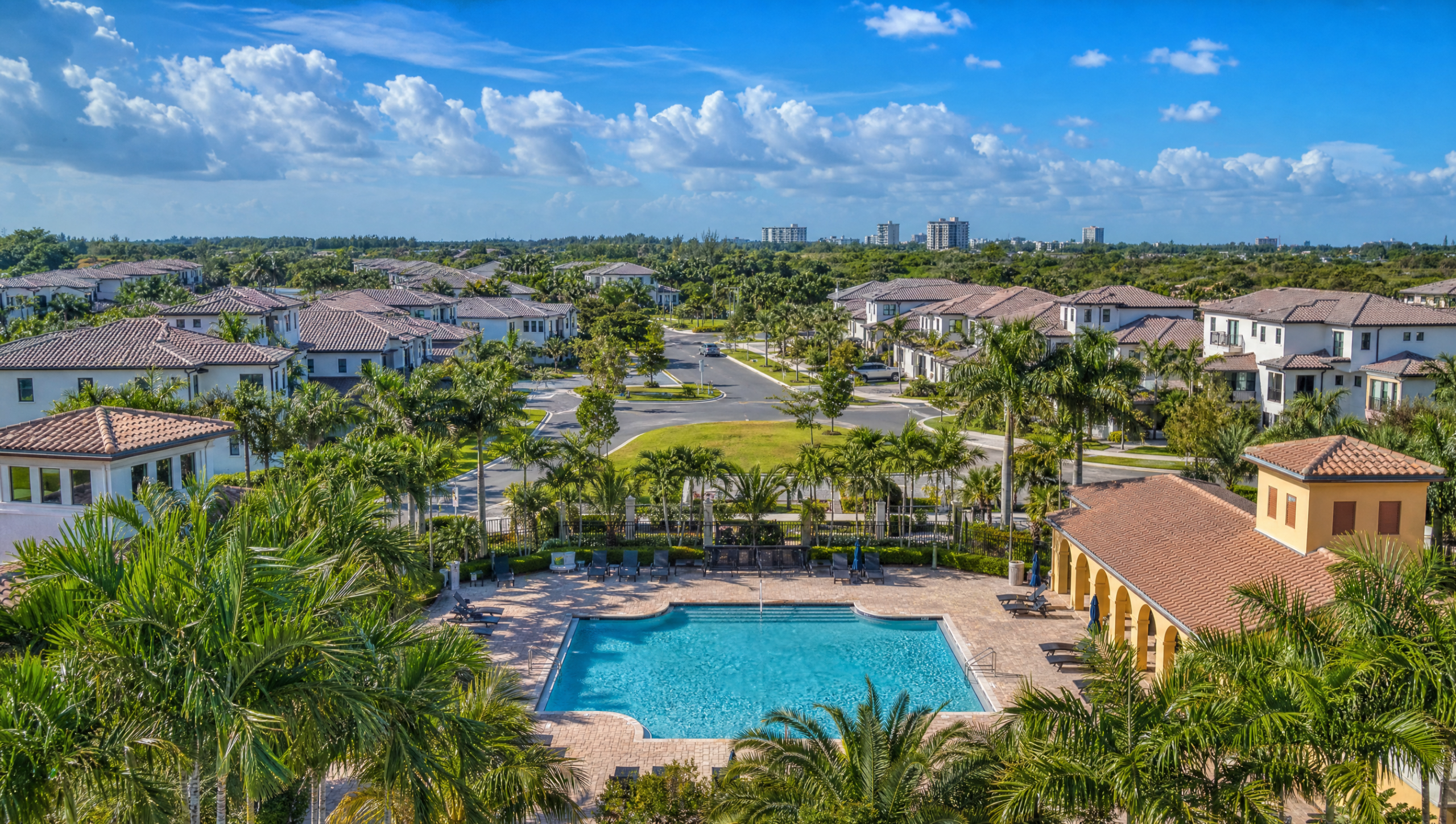 Coconut Creek cost of living residential community with Mediterranean-style townhomes and tropical landscaping
